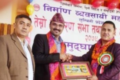 "Mr. Majgainya receiving an appreciation certificate from Mr. Balibhadra Rana, President of the Federation of Contractors Association."