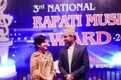 "Shashi Sharma Majgainya is conducting the Rapati Music Award public program alongside famous singer Komal Oli in 2014"